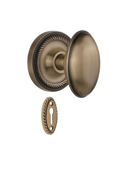 Rope Rosette Mortise-Lock Set with Homestead Knobs in Antique Brass.